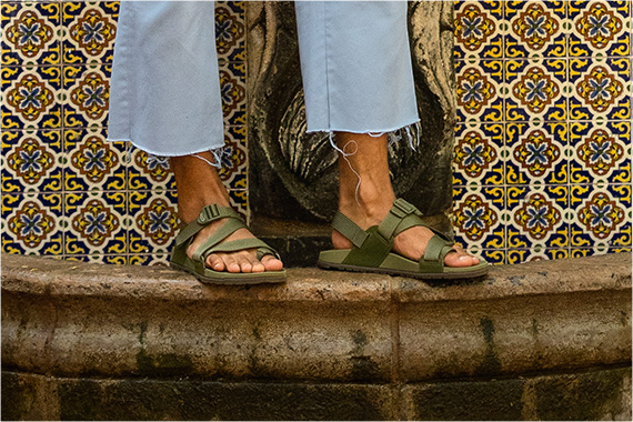 Rocking some Lowdown sandals while balancing on a stone ledge.