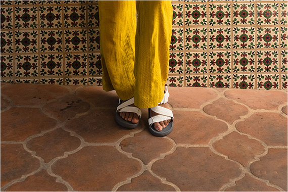 Standing feet together on a double-sided spade shaped tile floor.