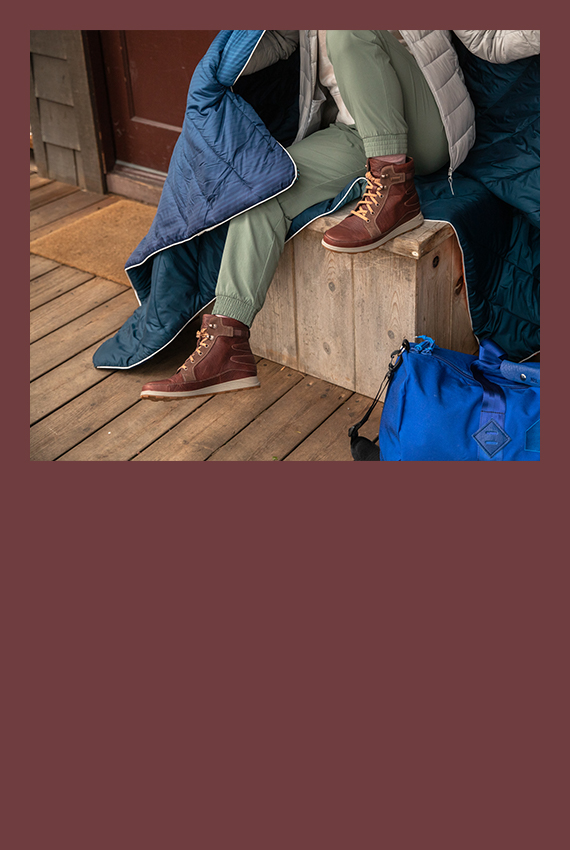 Preparing for outdoor adventures on the porch of a cabin.