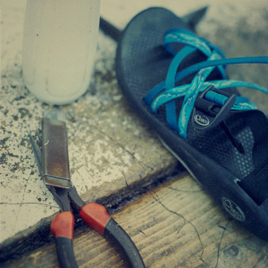 An old Chaco sandal on a work bench.