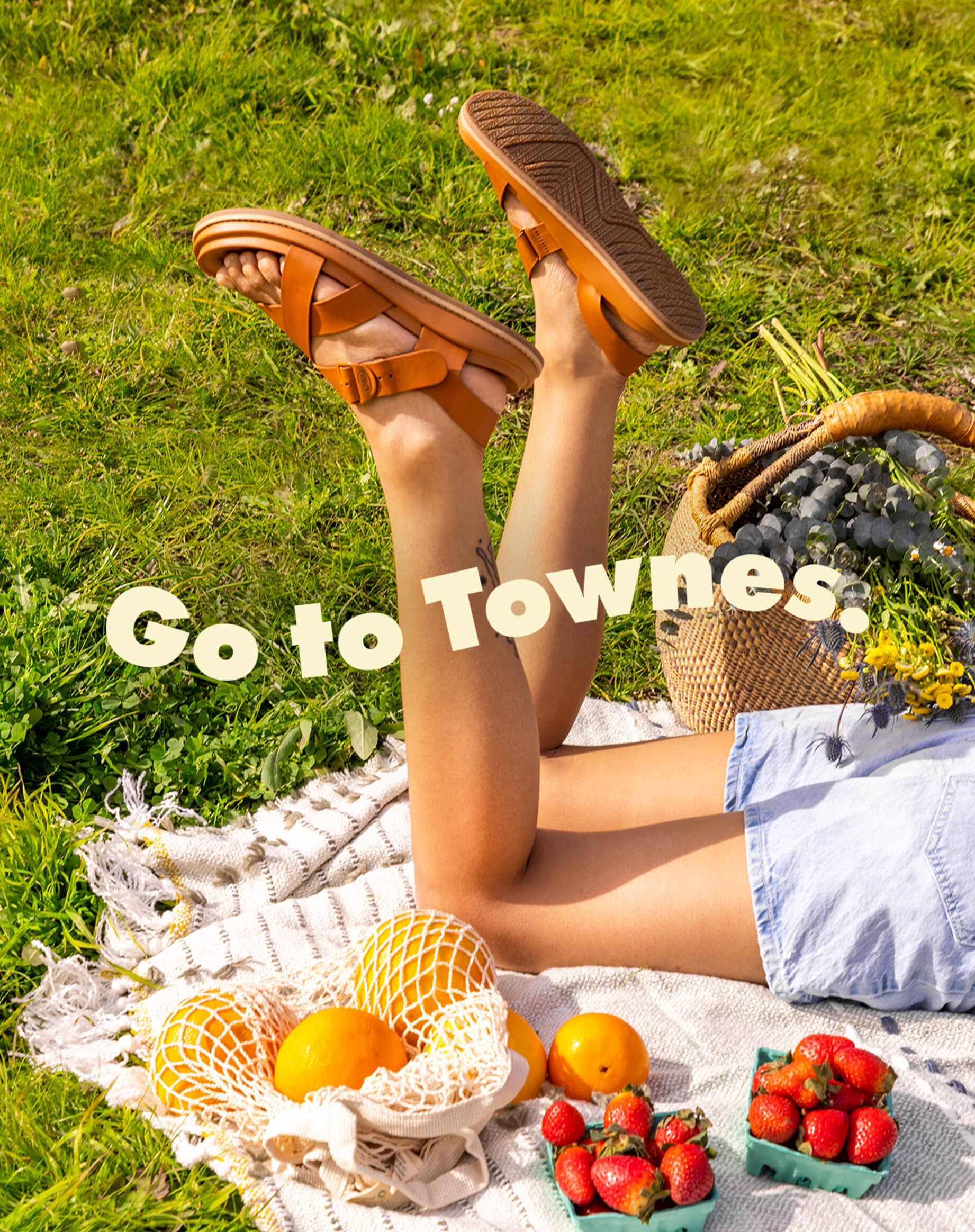 Person enjoying a picnic while wearing a pair of Townes sandals.
