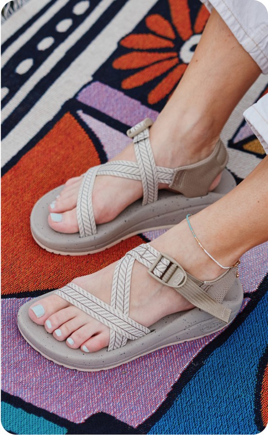 CushZ sandals on a brightly-colored rug.