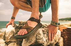 close up of chacos on rocks