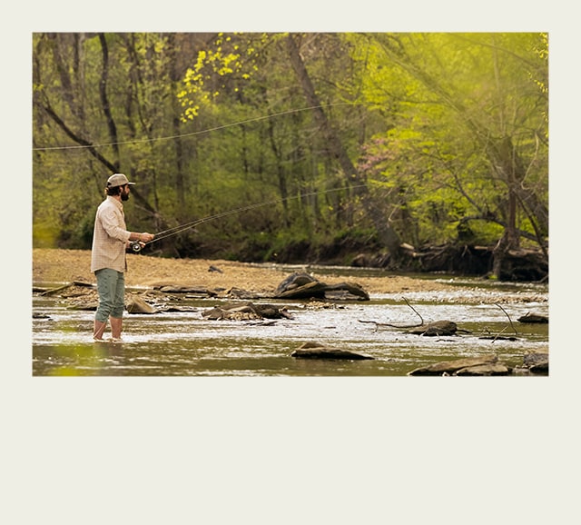 Man fishing in a river.