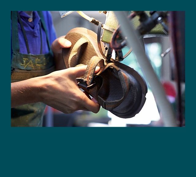 Person assembling a Chaco sandal.