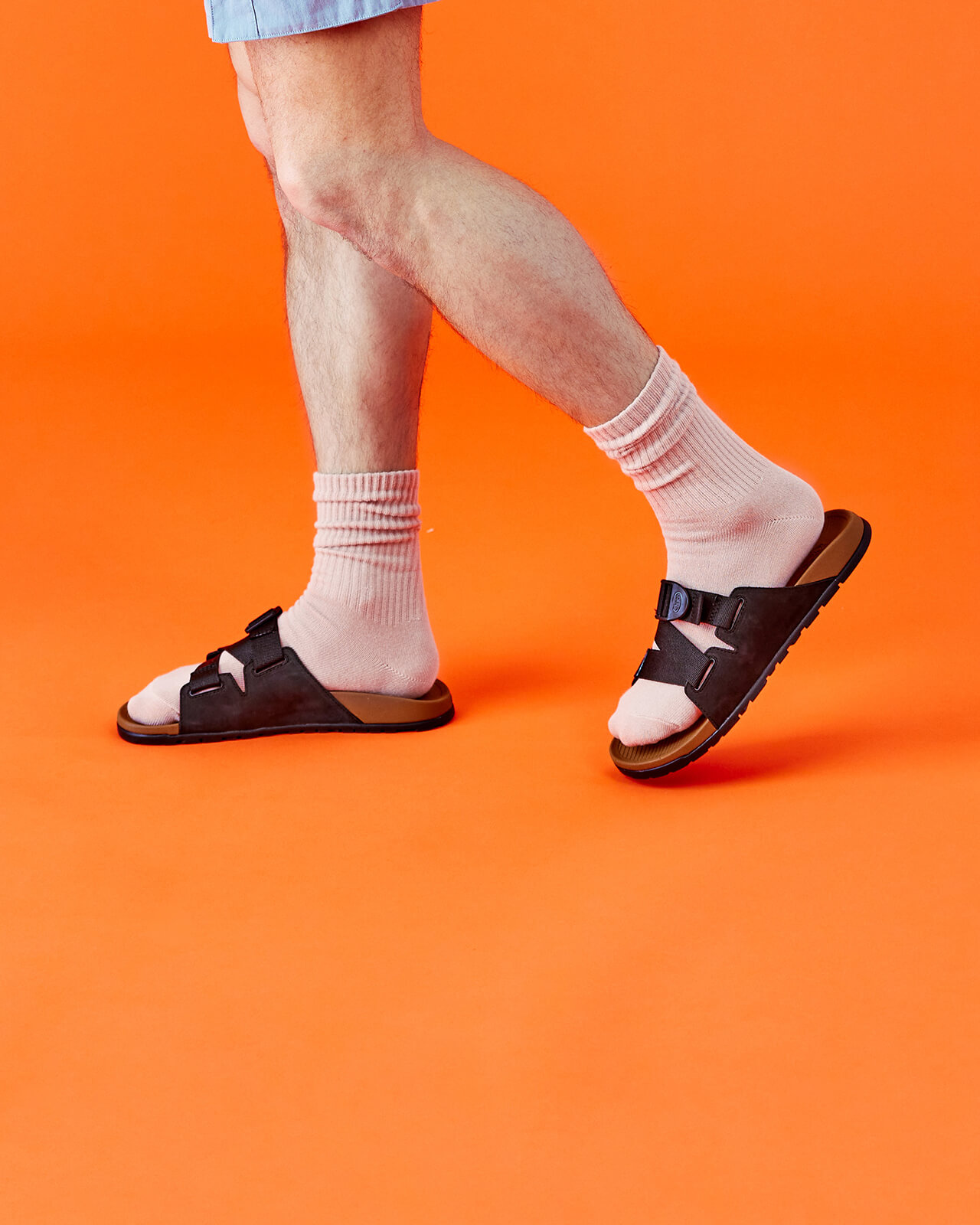 Man wearing socks and leather Chaco sandal