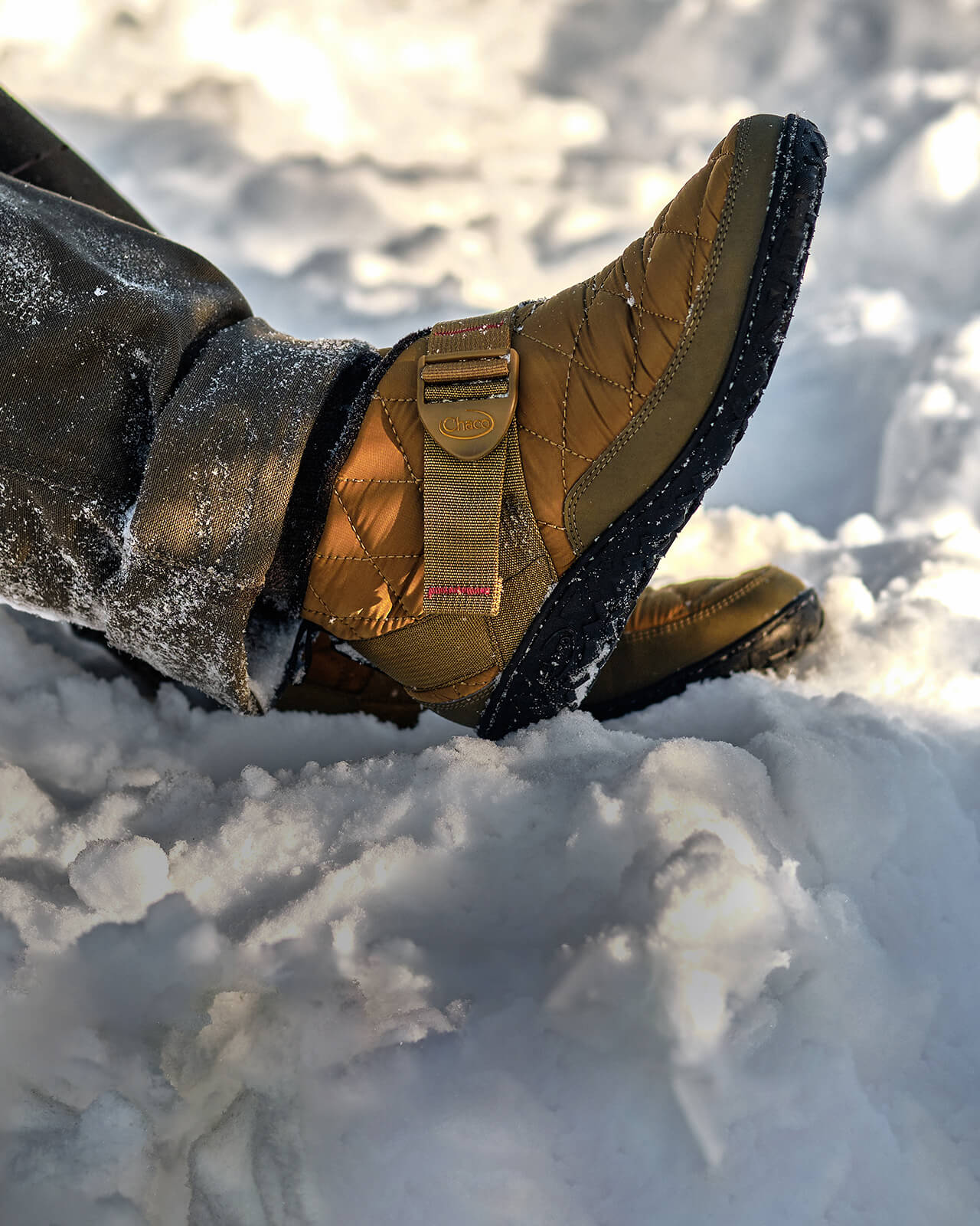 Person wearing Chaco Ramble Puffs outside in the snow