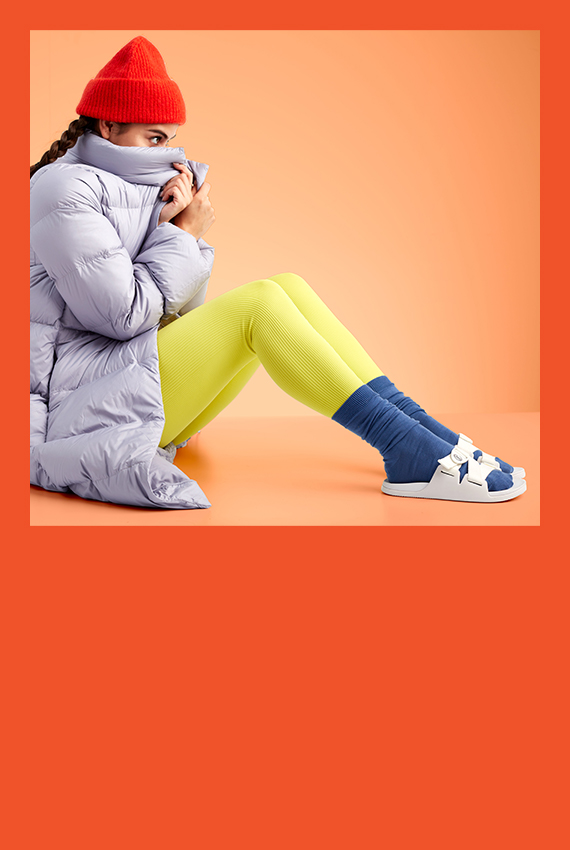 A girl bundled up in winter attire wearing some Chillos with socks.