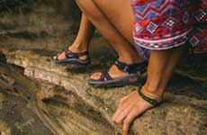 close up of chacos on rocks