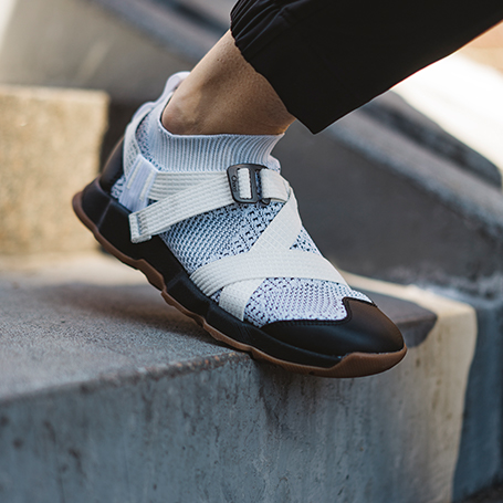 Person walking down stairs wearing Chaco shoes